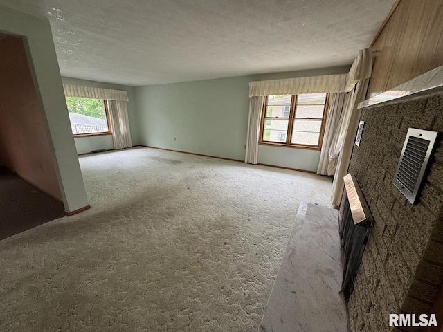4528 5th St Unit B, East Moline, IL 61244 - unfurnished living room featuring light carpet and a textured ceiling