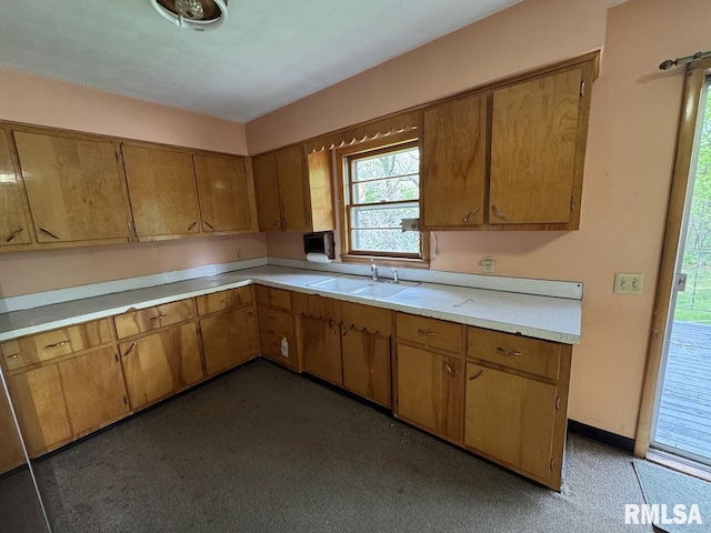 4528 5th St Unit B, East Moline, IL 61244 - kitchen featuring light countertops, a sink, and brown cabinets