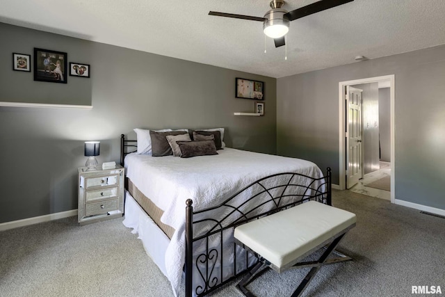 bedroom with light colored carpet, a textured ceiling, baseboards, and visible vents