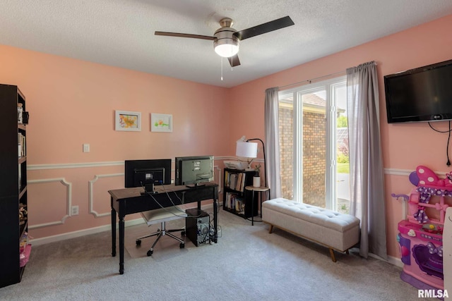 office space with a ceiling fan, carpet flooring, a textured ceiling, and baseboards