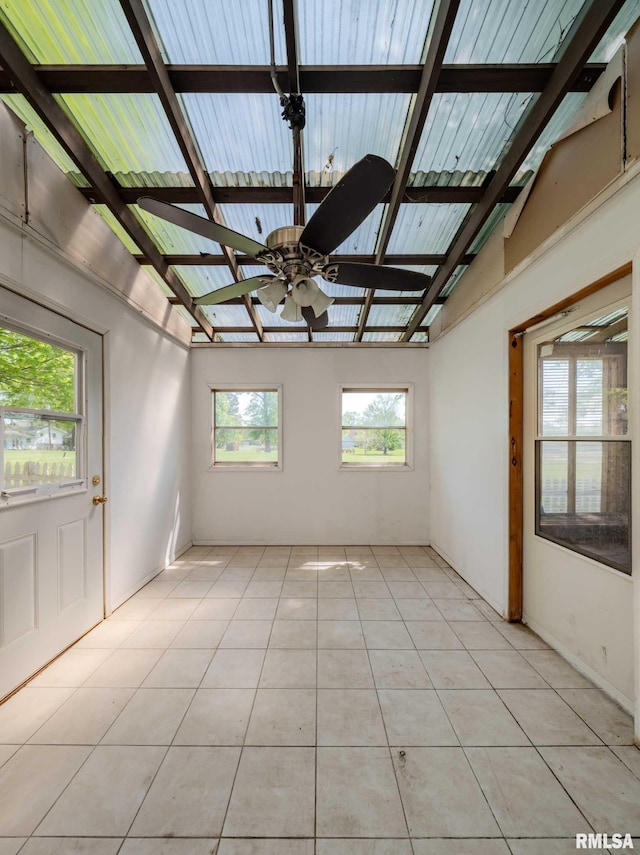 unfurnished room with light tile patterned floors, lofted ceiling with beams, and ceiling fan