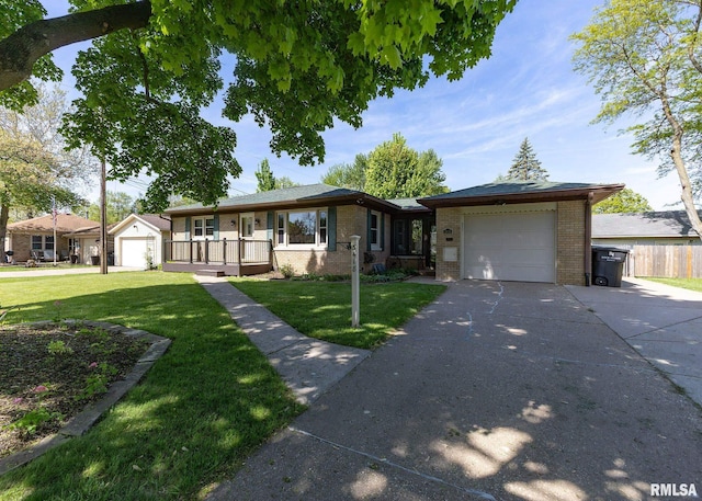 3418 25th St, Rock Island, IL 61201 - single story home with brick siding, a garage, concrete driveway, and a front yard