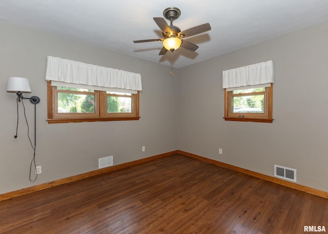 3418 25th St, Rock Island, IL 61201 - empty room featuring healthy amount of natural light, baseboards, wood finished floors, and a ceiling fan