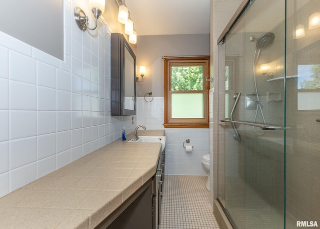 3418 25th St, Rock Island, IL 61201 - full bath featuring tile walls, a shower stall, vanity, tile patterned floors, and toilet