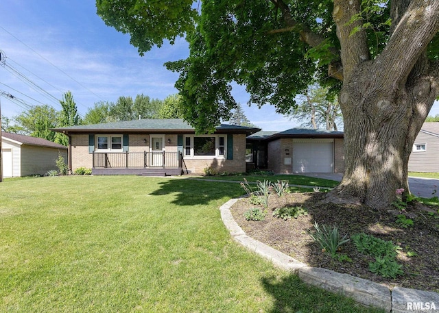3418 25th St, Rock Island, IL 61201 - single story home with covered porch, an attached garage, brick siding, and a front yard