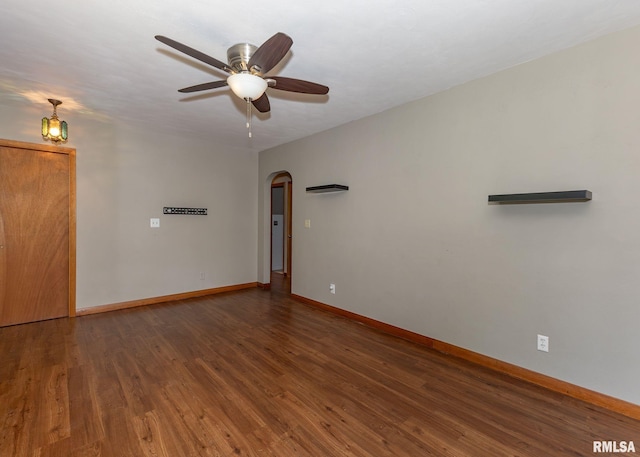 3418 25th St, Rock Island, IL 61201 - spare room with arched walkways, a ceiling fan, baseboards, and wood finished floors