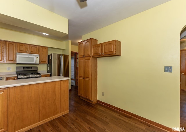 3418 25th St, Rock Island, IL 61201 - kitchen with appliances with stainless steel finishes, dark wood-style floors, light countertops, baseboards, and brown cabinets