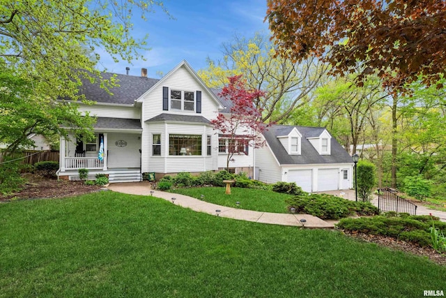view of front of house with a garage, fence, a front yard, a porch, and roof with shingles