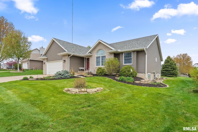 ranch-style house featuring a front yard, a shingled roof, a garage, and concrete driveway
