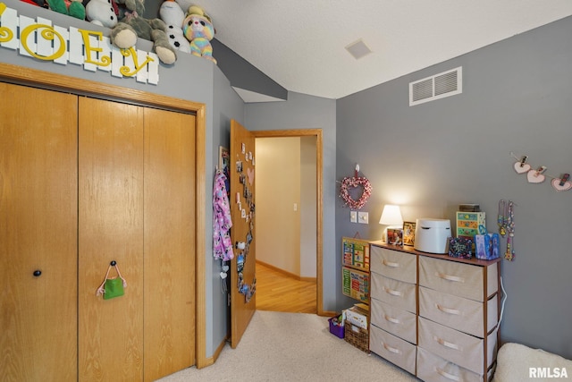 bedroom featuring a closet, visible vents, and carpet