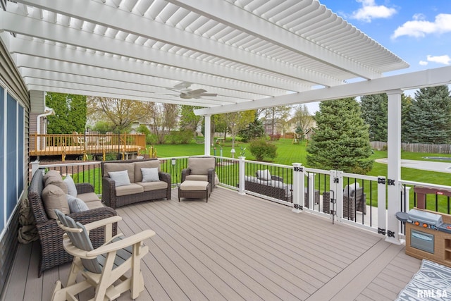 deck with outdoor lounge area, a yard, a pergola, and a ceiling fan