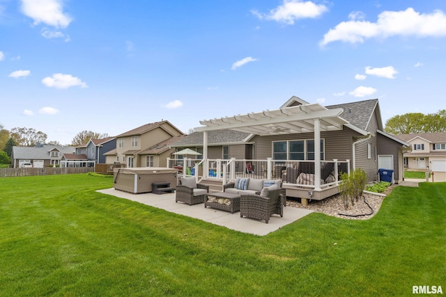 rear view of house featuring a hot tub, a deck, a pergola, a lawn, and outdoor lounge area