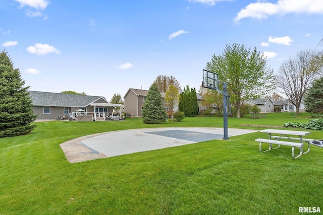view of basketball court featuring a yard and community basketball court