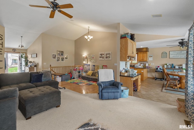 living room featuring light colored carpet, vaulted ceiling, and ceiling fan with notable chandelier