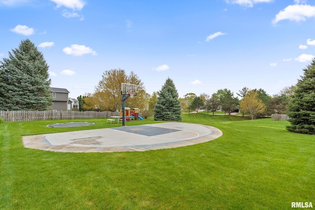 view of sport court with a playground, a yard, and fence