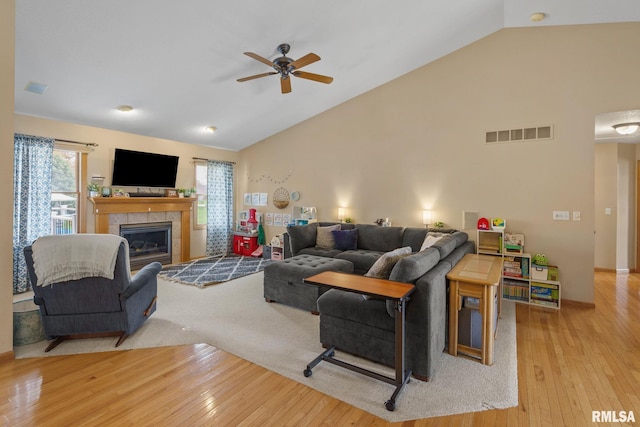 living room with a ceiling fan, hardwood / wood-style floors, a healthy amount of sunlight, and visible vents