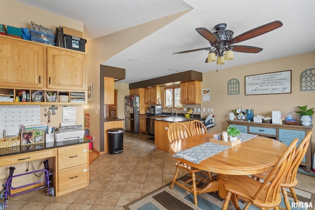 dining area featuring ceiling fan, a textured ceiling, and light tile patterned floors