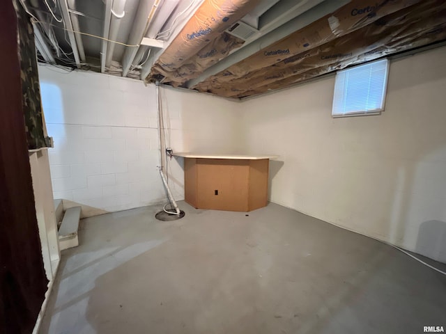 basement featuring visible vents and concrete block wall