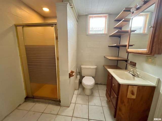 bathroom featuring tile patterned floors, vanity, toilet, and a stall shower
