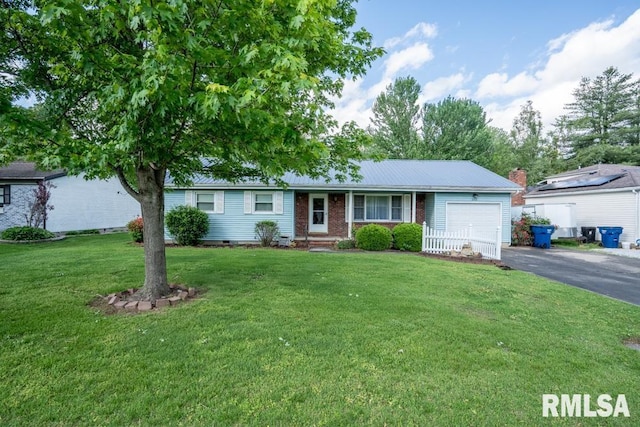 ranch-style house with a garage, metal roof, a front lawn, brick siding, and driveway