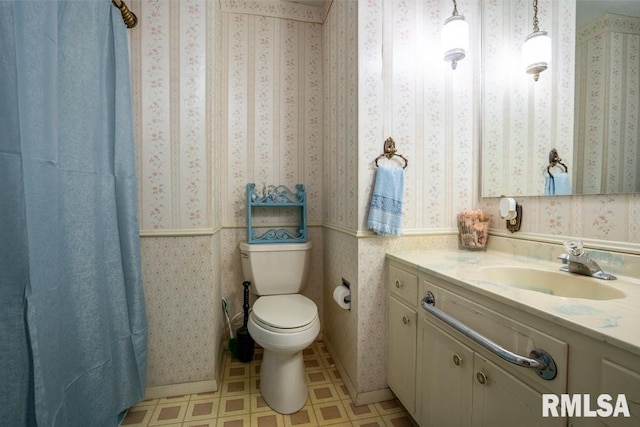 bathroom featuring vanity, toilet, wallpapered walls, and tile patterned floors