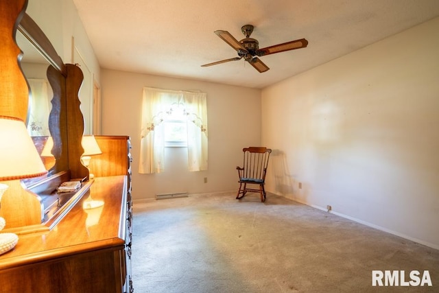 carpeted office space with baseboards and a ceiling fan