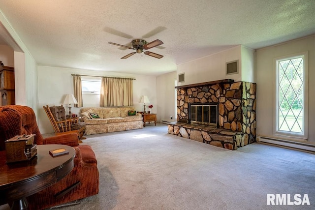 living area with a ceiling fan, baseboard heating, and a textured ceiling