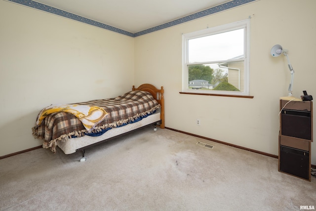 carpeted bedroom with visible vents and baseboards