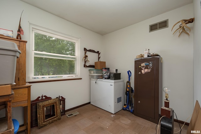 washroom with baseboards and visible vents