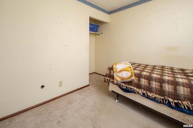 sitting room with baseboards and carpet floors