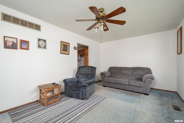 living area featuring carpet, visible vents, baseboards, and ceiling fan