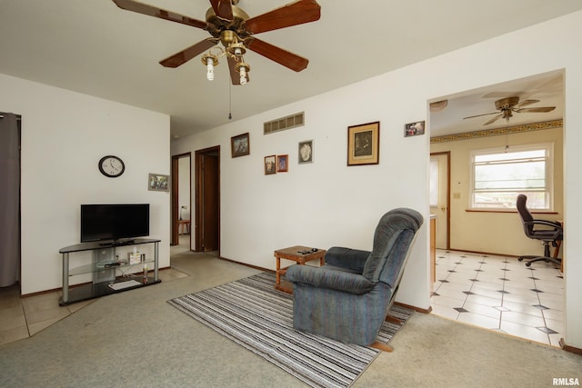 carpeted living area featuring ceiling fan and visible vents