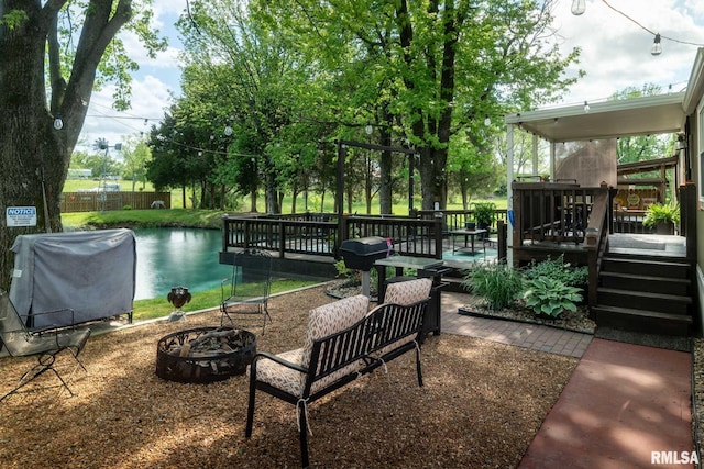 view of patio / terrace featuring an outdoor fire pit, a deck, and area for grilling