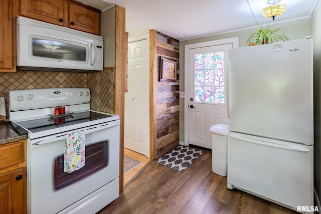 208 E Alexander St, Energy, IL 62933 - kitchen with white appliances, dark wood-style flooring, tasteful backsplash, brown cabinets, and dark countertops