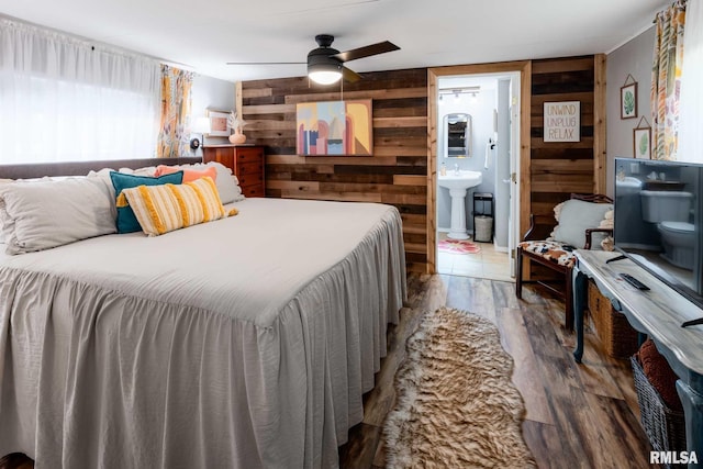 208 E Alexander St, Energy, IL 62933 - bedroom with wood finished floors, a sink, wood walls, ceiling fan, and ensuite bath