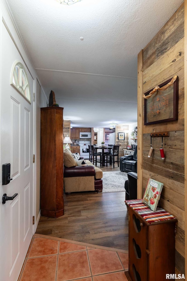 208 E Alexander St, Energy, IL 62933 - corridor featuring tile patterned flooring, wood walls, and a textured ceiling