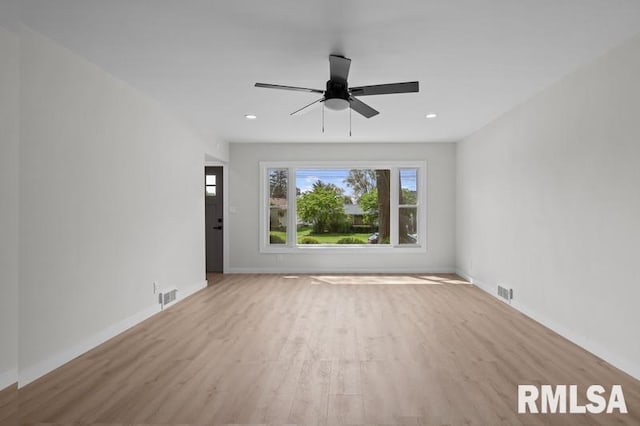 unfurnished living room featuring visible vents, wood finished floors, baseboards, and ceiling fan