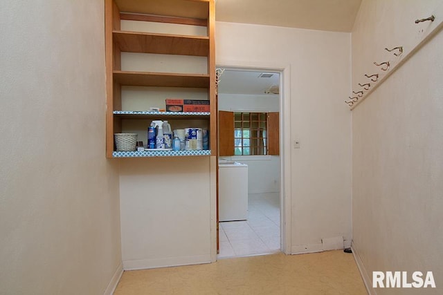 interior space featuring baseboards and washer / clothes dryer