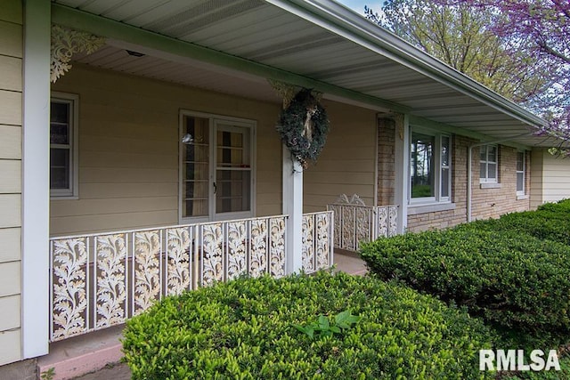 property entrance featuring stone siding and a porch
