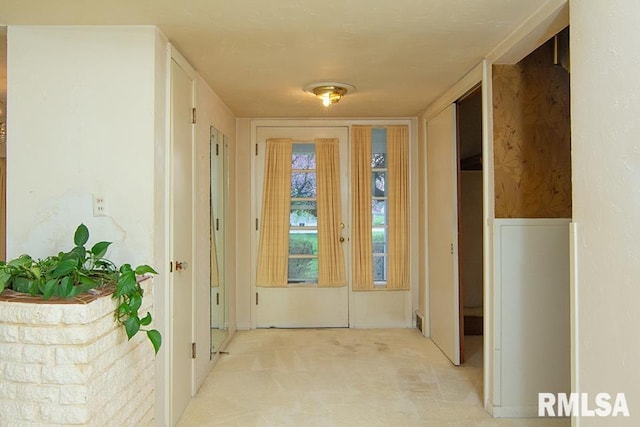hall featuring light colored carpet