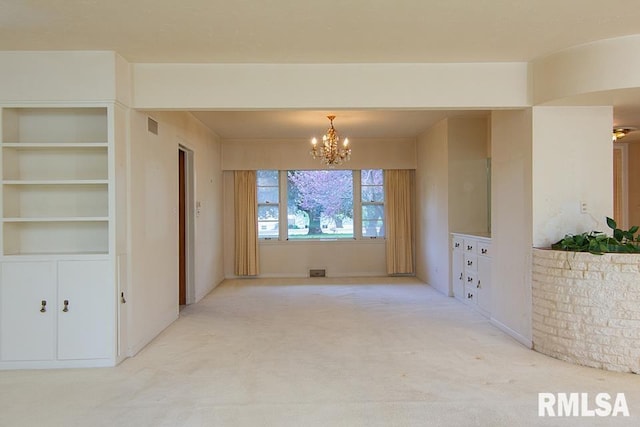 unfurnished room featuring a chandelier, light carpet, and visible vents