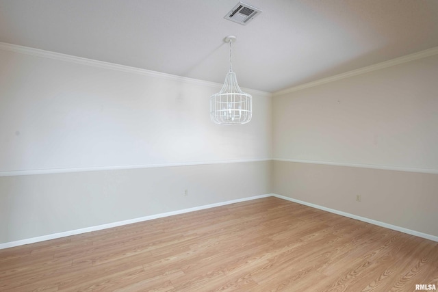 1360 Kimberly Ridge Rd Unit 309, Bettendorf, IA 52722 - unfurnished room with a notable chandelier, baseboards, ornamental molding, light wood finished floors, and visible vents