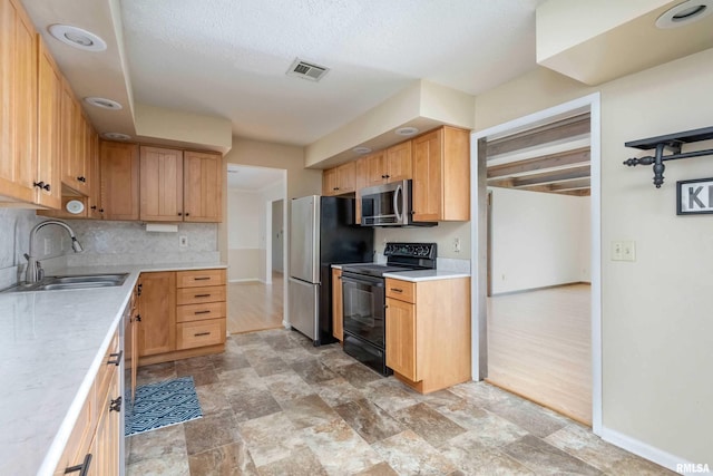 1360 Kimberly Ridge Rd Unit 309, Bettendorf, IA 52722 - kitchen with light countertops, stainless steel appliances, visible vents, and a sink