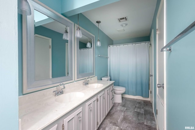 1360 Kimberly Ridge Rd Unit 309, Bettendorf, IA 52722 - full bath featuring double vanity, visible vents, wood finished floors, and a sink