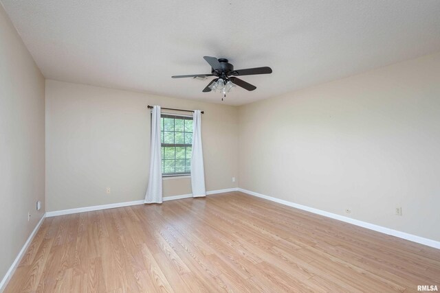 1360 Kimberly Ridge Rd Unit 309, Bettendorf, IA 52722 - unfurnished room with light wood-style flooring, ceiling fan, and baseboards