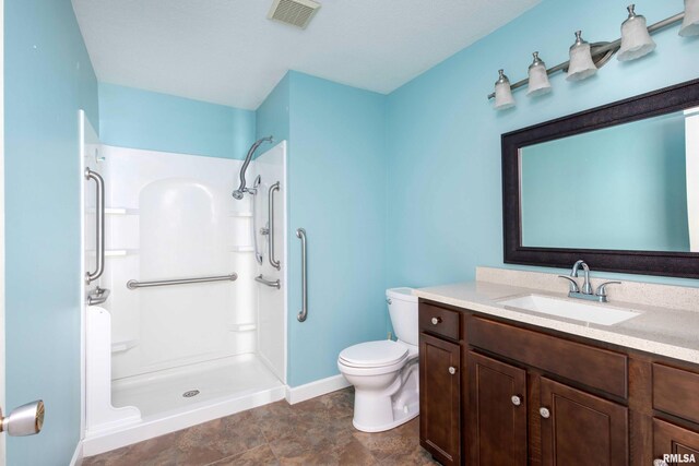 1360 Kimberly Ridge Rd Unit 309, Bettendorf, IA 52722 - bathroom featuring toilet, a shower, baseboards, and vanity