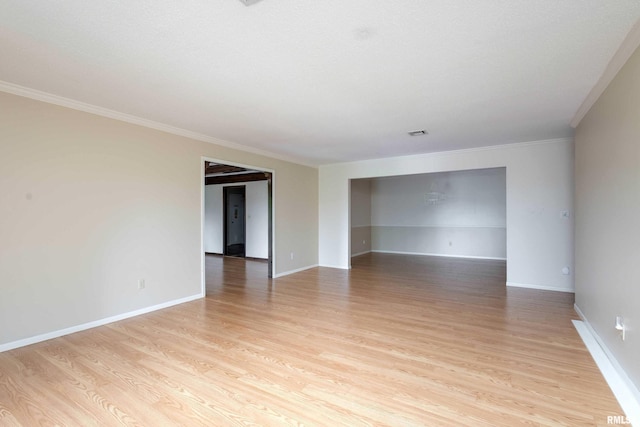 1360 Kimberly Ridge Rd Unit 309, Bettendorf, IA 52722 - spare room featuring visible vents, light wood-style flooring, baseboards, and ornamental molding