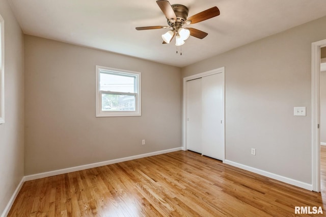 unfurnished bedroom with baseboards, a closet, and light wood-type flooring
