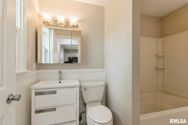 bathroom with toilet, shower / bathing tub combination, and vanity