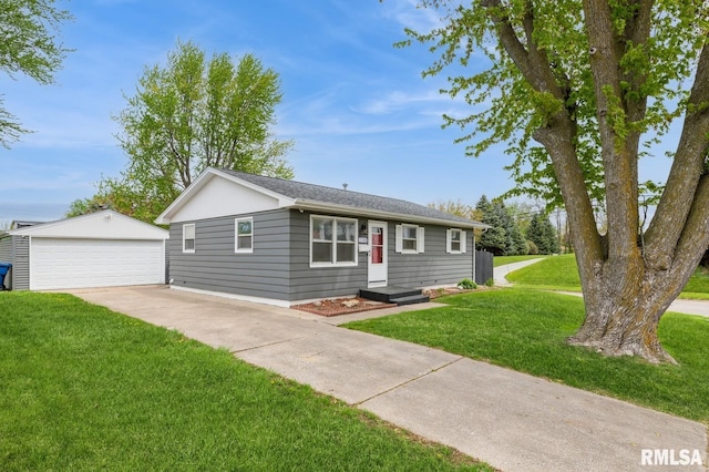 single story home featuring a front yard, an outbuilding, and a detached garage